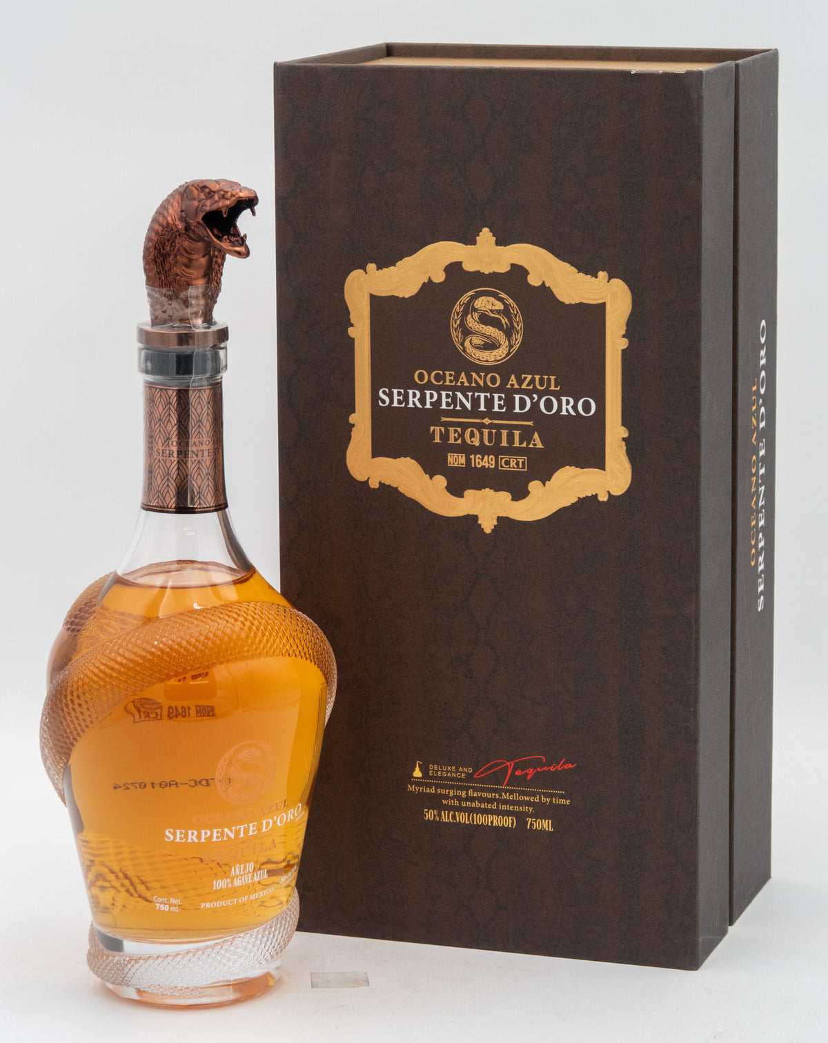Tequila bottle with serpent design next to its packaging box on a white background