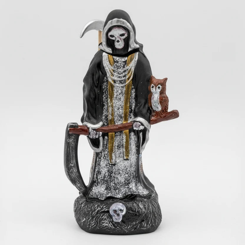 A bottle of Oceano Azul Grim Reaper Anejo Tequila featuring a decorative figure of a grim reaper holding a skull, seated next to a skull, with a small owl perched on the reaper's shoulder.