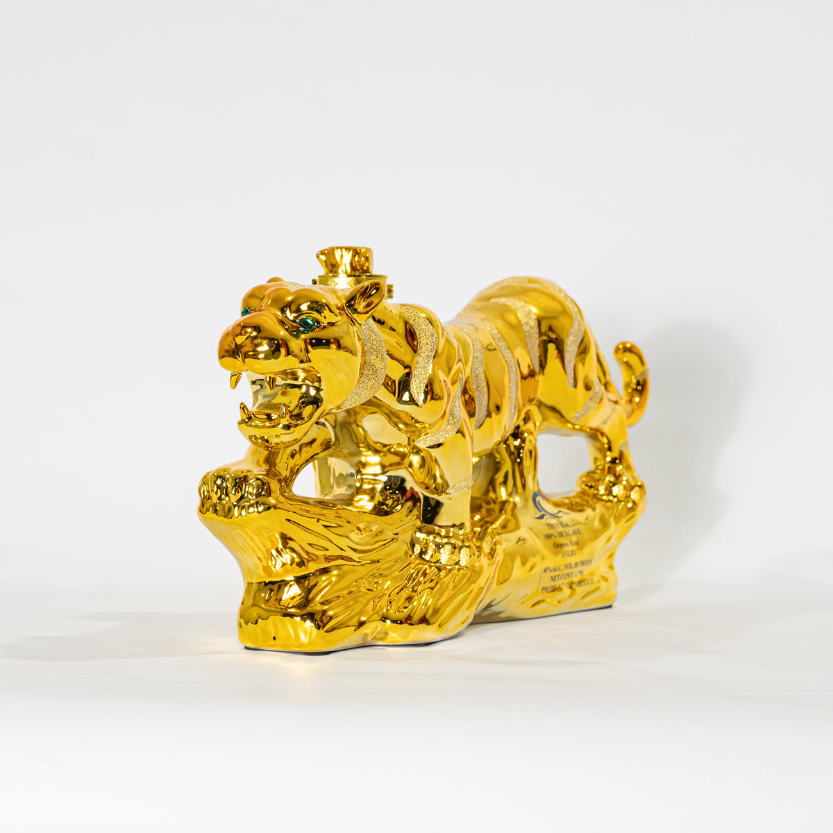 Gold tiger figurine on a white background