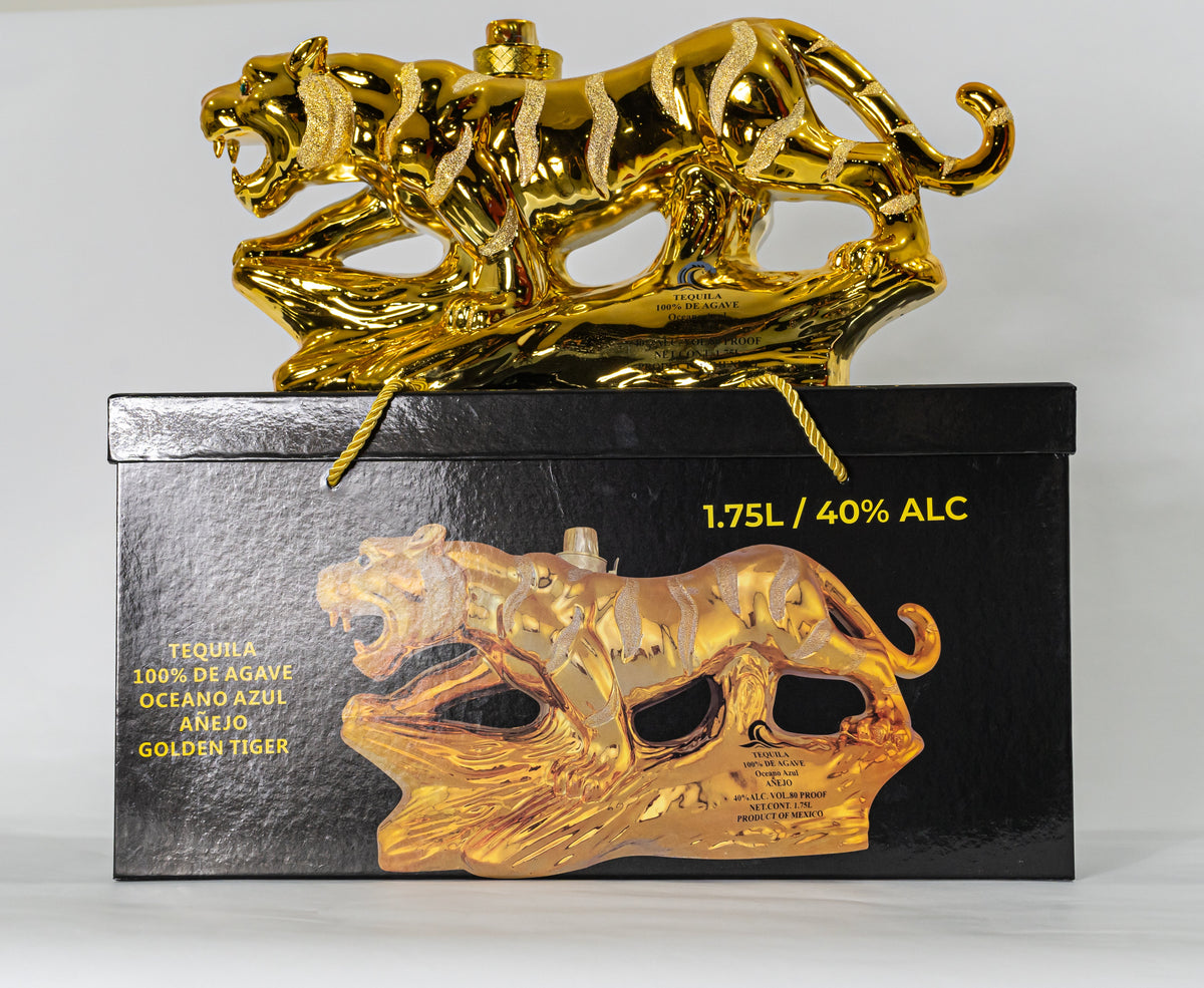 Tequila bottle with gold tiger design on a black box against a white background