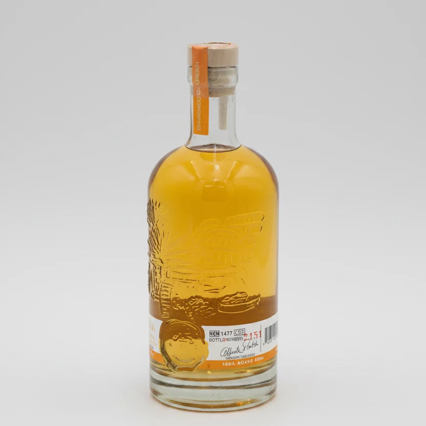 Bottle of alcohol with a label on a white background