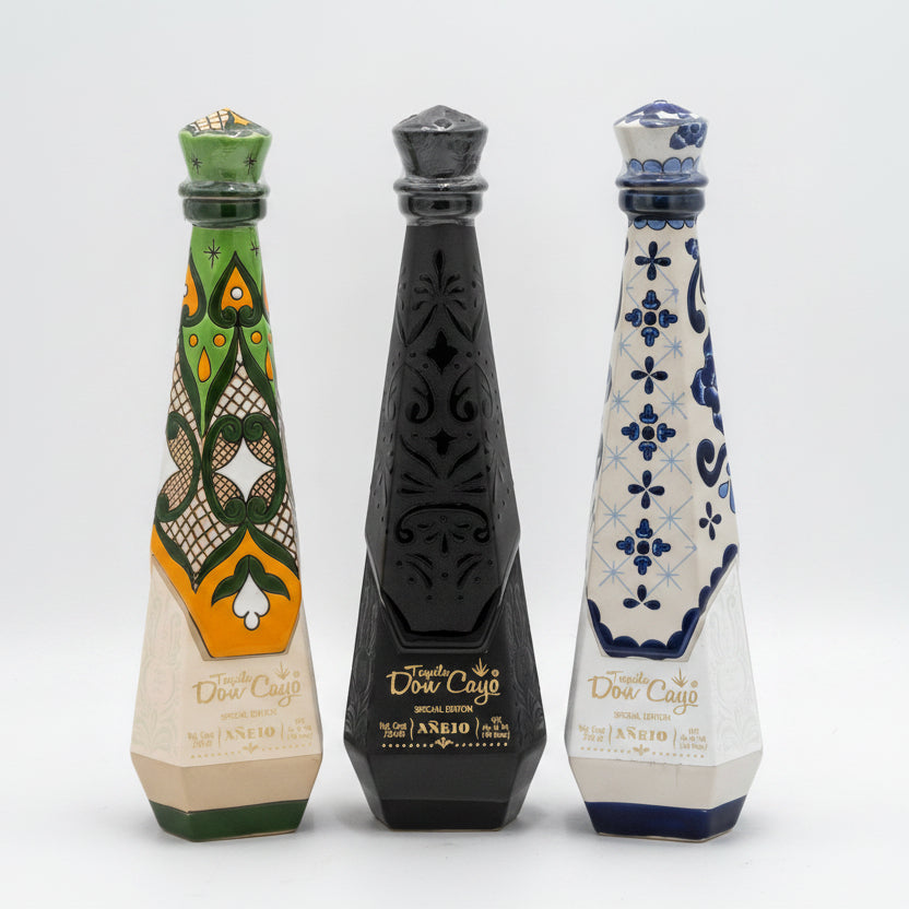 Three decorated bottles with intricate designs on a white background