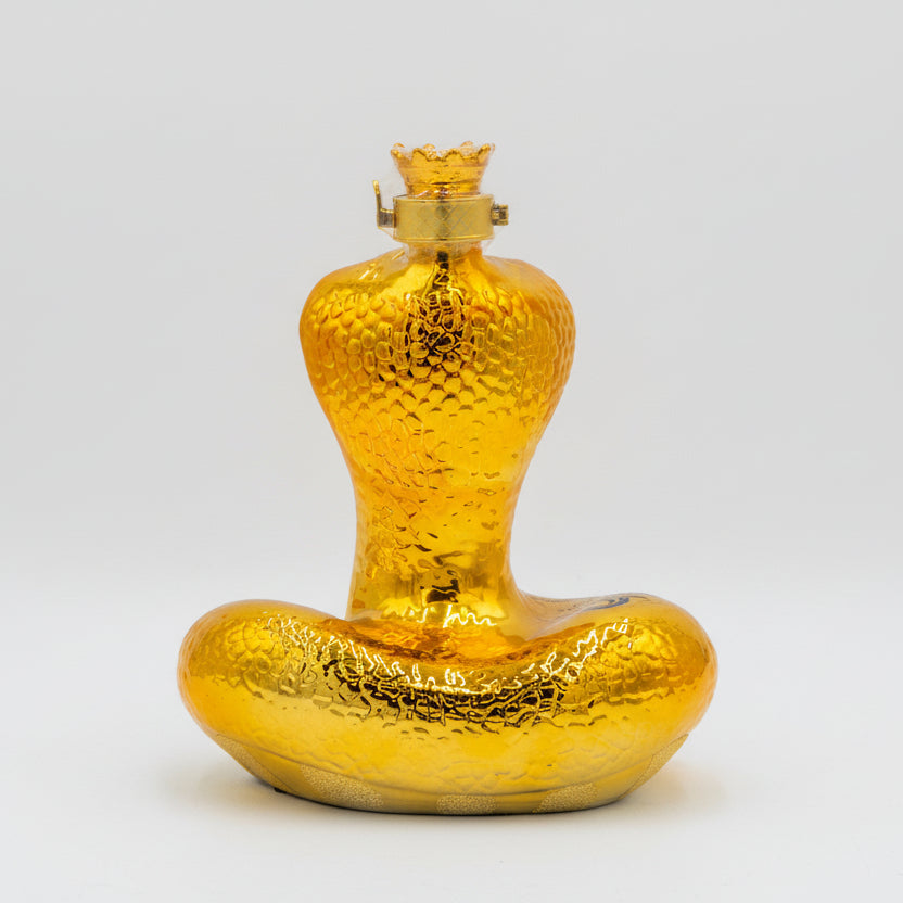 Gold-colored bottle with a textured surface on a white background