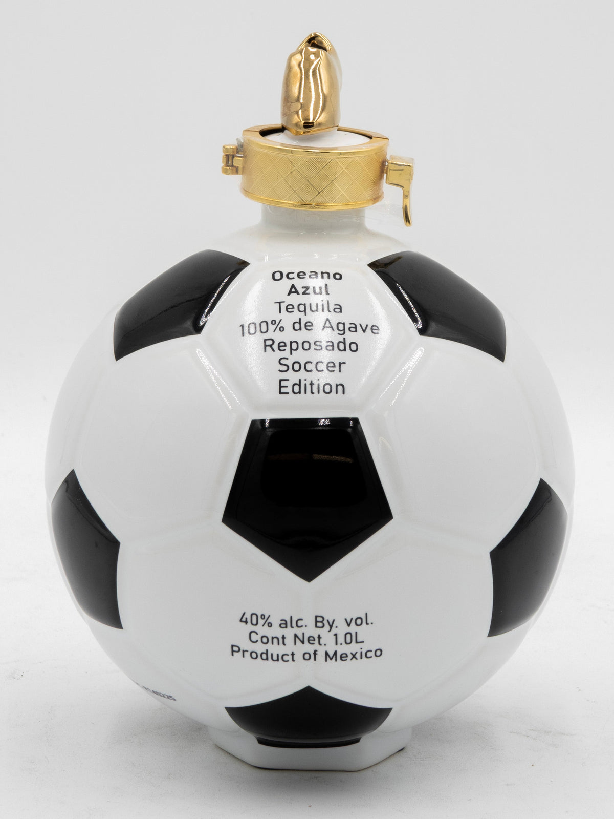 Soccer ball-shaped tequila bottle with gold cap on a white background