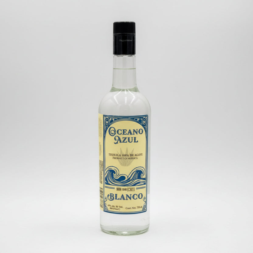 A bottle of Oceano Azul Blanco Tequila with a white label featuring blue and black text, and an illustration of ocean waves.
