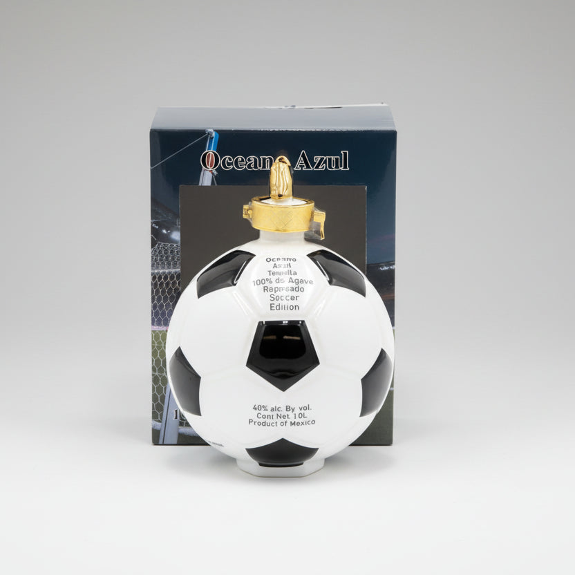 Soccer ball-shaped tequila bottle with gold cap and 'Oceano Azul' branding on a white background.